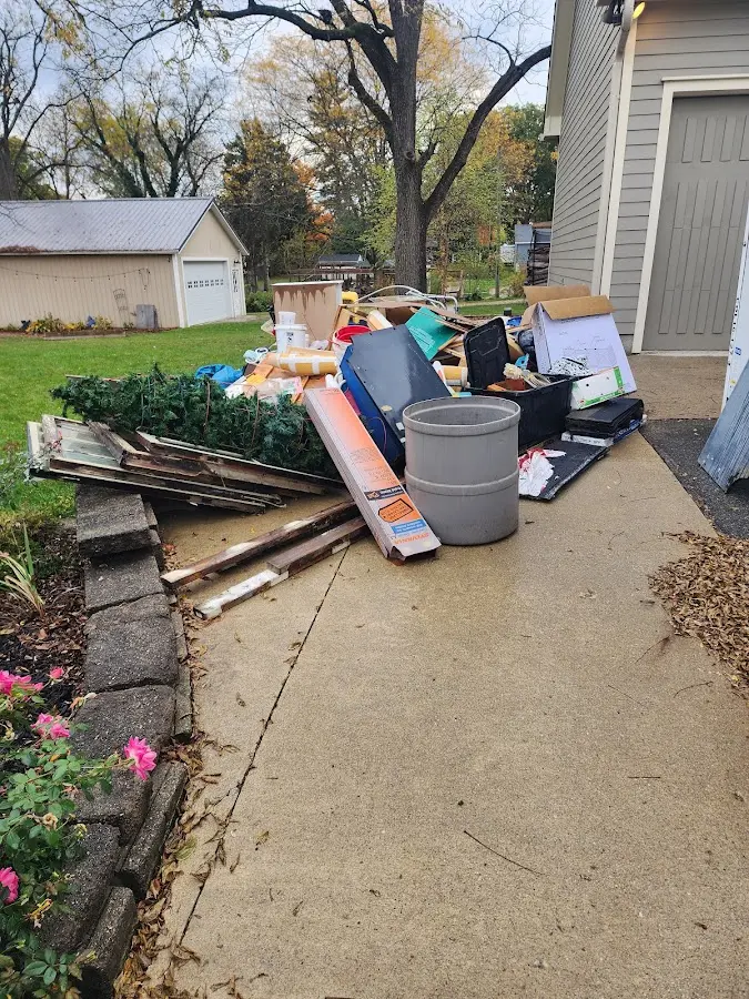 Dumpster being loaded with debris for Roofing Dumpster Rental in Fort Morgan
